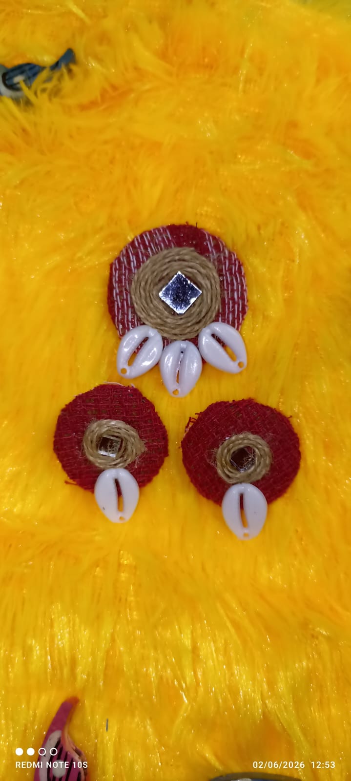 Hand-embroidered jewellery on yellow textile
